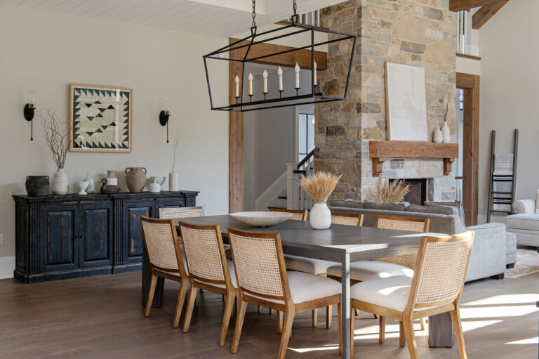 Dining room with stone fireplace in a Veloce home