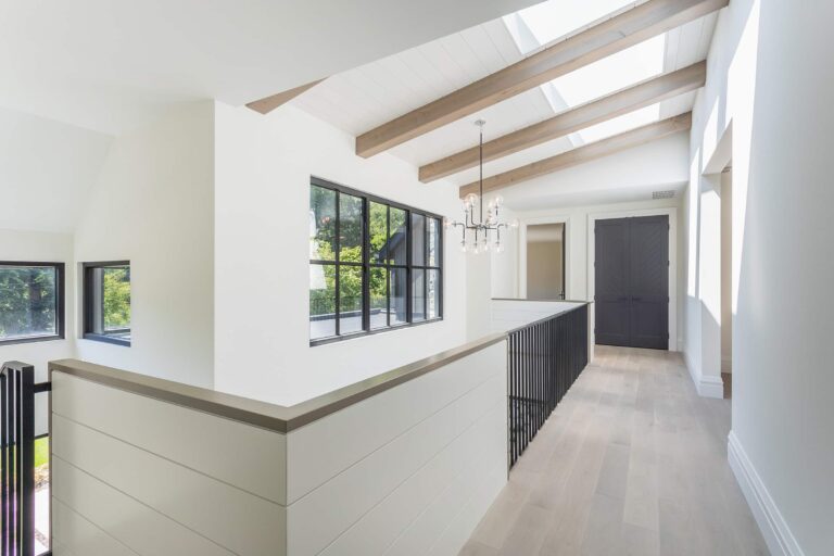 Upper hallway with tall windows in a Veloce home