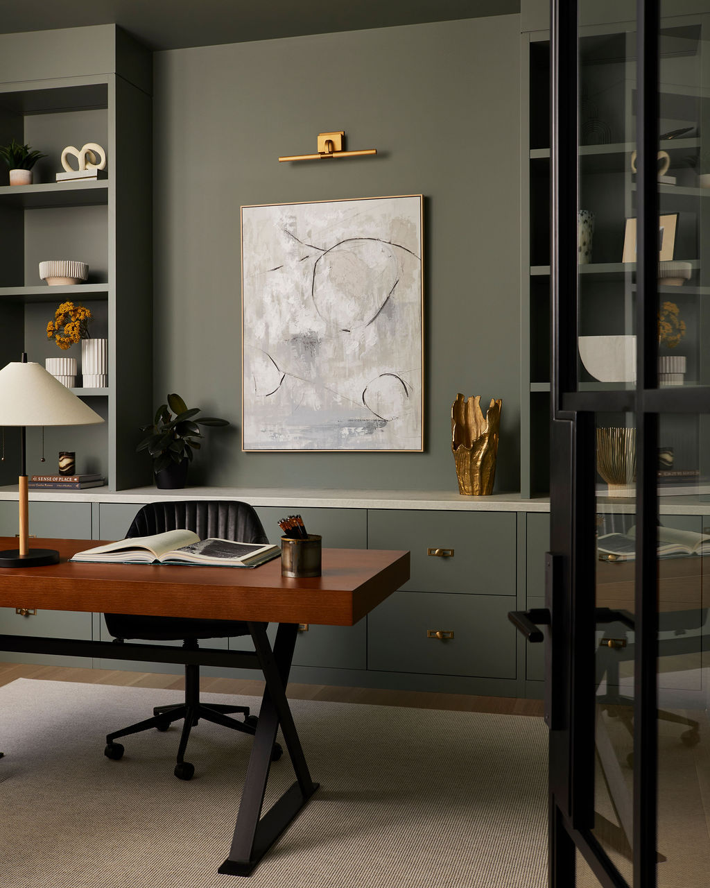 Veloce Homes interior: sage green home office with built-in shelving and walnut desk